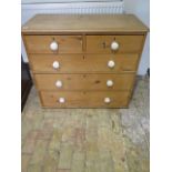 A Victorian stripped pine five drawer chest with ceramic handles - Height 85cm x 97cm x 45cm