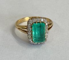 A good yellow gold emerald and diamond ring - The central rectangular round corner step cut