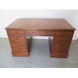 A Victorian style elm veneered twin pedestal 8 drawer desk with a leather inset top - Height 77cm