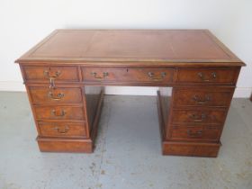 A Victorian style elm veneered twin pedestal 8 drawer desk with a leather inset top - Height 77cm