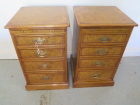 A pair of burr oak four drawer bedside chests each with a slide - made by a local craftsman to a