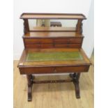 A Victorian mahogany writing desk with a mirrored four drawer upstand above a leather inset