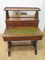 A Victorian mahogany writing desk with a mirrored four drawer upstand above a leather inset