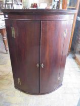 A Georgian bow fronted mahogany corner cupboard with three internal drawers - Height 121cm x Width