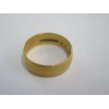 A hallmarked 18ct yellow gold band ring - 6.5mm band - ring size T - approx weight 6.6 grams -