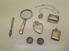 A silver page marker, two silver buttons, silver perfume bottle, silver box, silver locket,