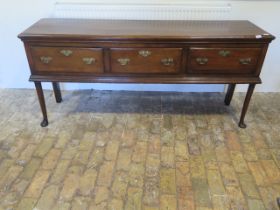 A Georgian style oak three drawer dresser on shaped front legs - Height 84cm x 187cmk x 46cm - in