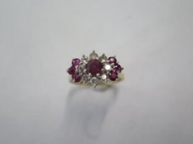 A yellow gold diamond and ruby type cluster ring - surface tests to approx 18ct - with a central