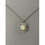 A stunning Opal and Diamond pendant/brooch 28.5mm diameter with a centre cabochon Opal approx 13.5mm