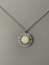A stunning Opal and Diamond pendant/brooch 28.5mm diameter with a centre cabochon Opal approx 13.5mm