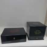 Two ebonised cigar humidors - largest with five internal trays and a base drawer - some staining, no