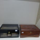A carved wooden Bolivar centenary cigar humidor and an ebonised humidor without key - 18cm x 38cm