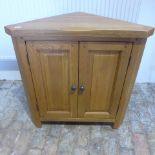 A solid oak corner cupboard 81 cm tall 80 cm wide in good condition