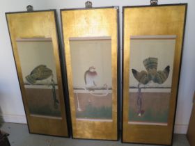 Three Oriental bird of prey scrolls mounted on a gilt background in ebonised frames, frame size