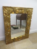 A modern ornate gilt mirror - 112cm x 87cm - in good condition