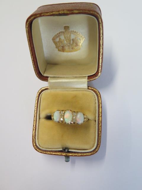 An 18ct yellow gold three stone opal ring set with small diamonds - ring size N - approx weight 4. - Image 4 of 4
