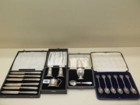 A boxed silver Christening set - no engraving - a boxed set of silver handle knives, a boxed set