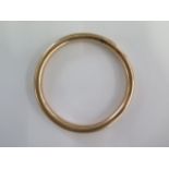 A 9ct gold hollow bangle - 8.5cm external - approx weight 18.4 grams - some dents and repairs