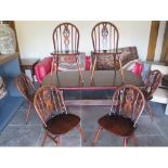 A vintage Ercol dining table and six matching chairs - 150cm x 75cm