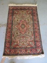 A fine woven silk mix rug with cream field and foliate design - 156cm x 95cm - some wear but