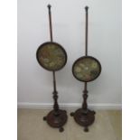 A pair of mahogany pole fire screens with needlework designs - Height 145cm