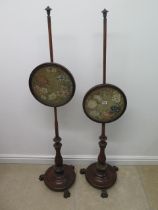 A pair of mahogany pole fire screens with needlework designs - Height 145cm