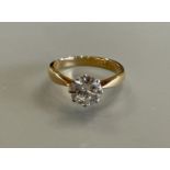 An 18ct yellow gold and platinum solitaire diamond ring - the round brilliant cut diamond approx 1.