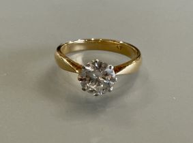 An 18ct yellow gold and platinum solitaire diamond ring - the round brilliant cut diamond approx 1.