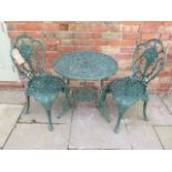 A vintage green painted rose design cast aluminium bistro set comprising table Diameter 65cm x