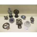 A collection of eight Royal Automobile Club Associate and other motoring car badges including AA