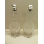 A pair of silver top cut glass pourers with umbrella insert tops London 1890/91 - Height 24cm -