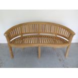 A brand new premium teak banana bench - Width 160cm x Height 84cm x Depth 57cm