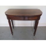 A 19th century mahogany foldover card table on turned reeded legs - Height 74cm x Width 91cm