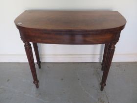 A 19th century mahogany foldover card table on turned reeded legs - Height 74cm x Width 91cm