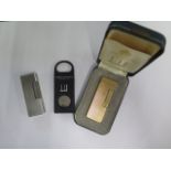 Two Dunhill gas lighters, a plastic cigar cutter - one lighter boxed