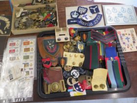 A collection of assorted Militaria including badges, buttons, cigarette cards etc