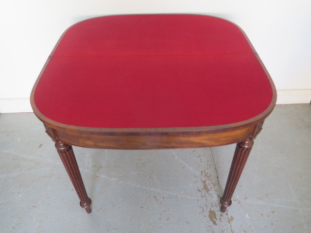 A 19th century mahogany foldover card table on turned reeded legs - Height 74cm x Width 91cm - Image 2 of 2