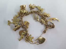 A 9ct yellow gold charm bracelet with 18 charms - total weight approx 41 grams