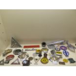 A collection of 26 motoring/car badges, a Rocket mascot and an Ariel Centenary nut cracker
