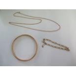 A 9ct yellow gold 58cm necklace, a 9ct bracelet and a hollow 9ct bangle - some dents to bangle but