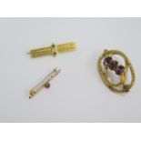 A 15ct gold brooch approx weight 4.3 grams, a 9ct gold brooch, approx weight 0.5 grams and a gilt