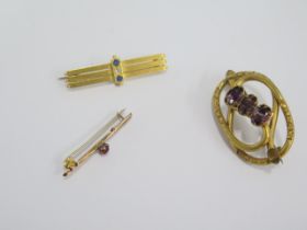 A 15ct gold brooch approx weight 4.3 grams, a 9ct gold brooch, approx weight 0.5 grams and a gilt