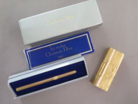 A Dunhill gold plated lighter with damage flint holder and a Christian Dior pen case - Length 9.