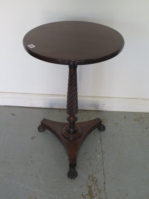 A mahogany wine table on a turned fluted column, platform base and cast iron claw feet - Height 73cm