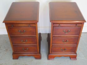 A 20th century pair of reproduction yew wood bedside chests with brushing slides - 61cm x 36cm x