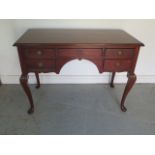 A circa 1920's mahogany five drawer desk/side table on cabriole legs - Height 76cm x 106cm x