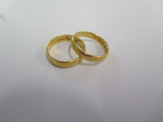 Two 22ct hallmarked yellow gold band rings sizes M and J - total weight approx 6.5 grams - both