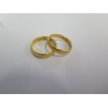 Two 22ct hallmarked yellow gold band rings sizes M and J - total weight approx 6.5 grams - both