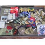 A collection of assorted Military badges, belts and buckles