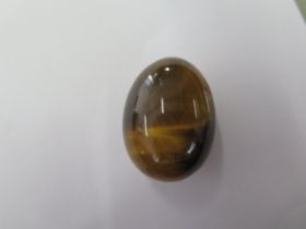 A Tigers Eye stone egg - 33mm tall - traditionally Tigers Eye was to ward off evil